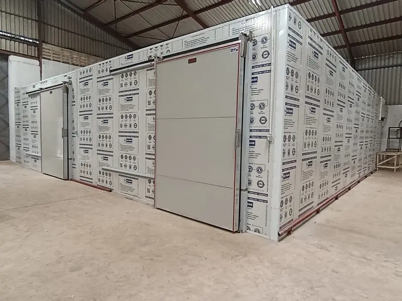 Modular ICE MAKE coldroom with two industrial sliding doors on a warehouse floor