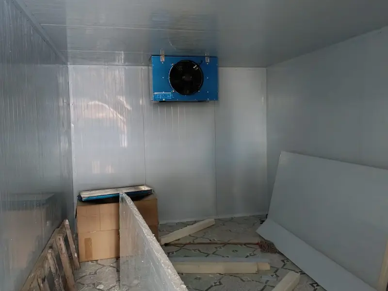 Coldroom interior during fit-out, with a wall-mounted evaporator and insulated panels