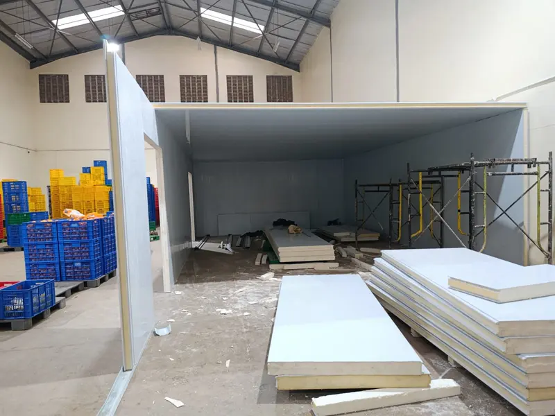 Coldroom being assembled from insulated sandwich panels inside a warehouse